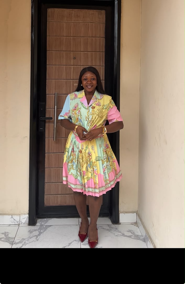 Woman wearing pastel baroque pleated shirt dress in mint green, yellow and pink